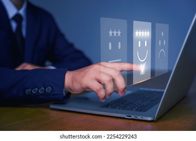 Business people are touching the virtual screen on the happy Smiley face icon to give satisfaction in service. Customer service and Satisfaction concept. rating very impressed. - Shutterstock ID 2254229243