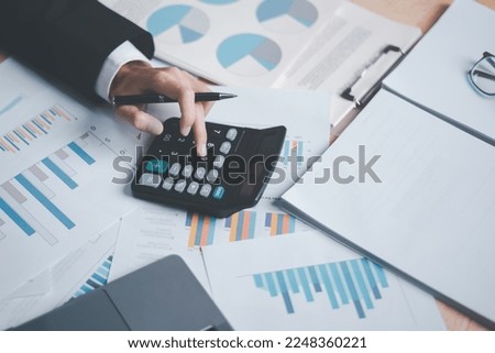 Business people use calculator to calculate documents, profit and loss statement review concept of company performance, effective tax deduction planning for individuals and companies paying tax rates 