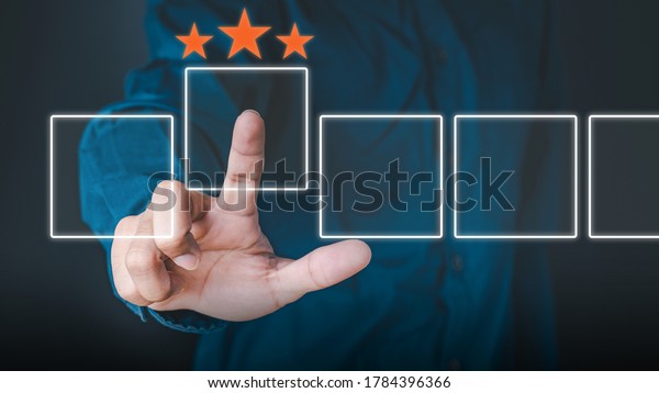 Business people use the index finger to touch\
the virtual screen to select the starred icons, future digital\
technology working in digital form, business strategy concepts,\
human business\
concepts.