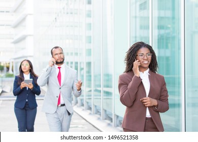 Business People Using Digital Gadgets Outside. Diverse Business Man And Women Walking Down City Street, Calling On Phone, Using Tablet. Digital Communication Concept