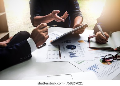 Business people using pen,tablet,notebook are planning a marketing plan to improve the quality of their sales in the future. - Shutterstock ID 758269021