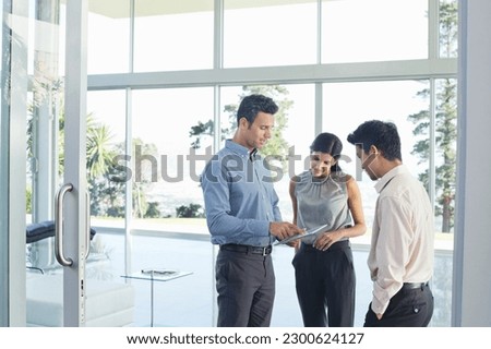 Business people using tablet computer in office
