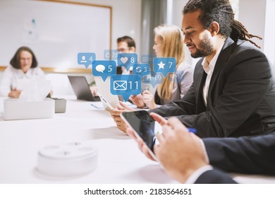 Business People Using Together In Business Meeting Or Are Distracted By Social Media