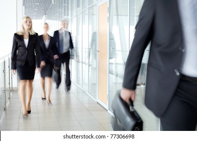 Business People Walking Along The Office Corridor