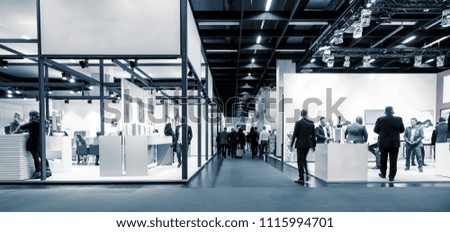 business people walking between trade show booths. ideal for websites and magazines layouts