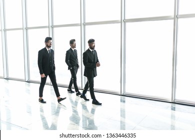 Business people walking in the office corridor