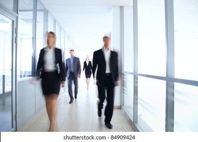 Business People Walking In The Office Corridor