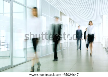 Business people walking in the office corridor