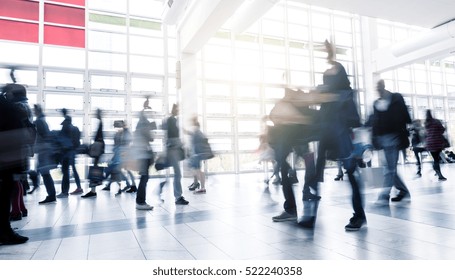 Business People Walking At Rush Hour On A Traid Fair Flloor