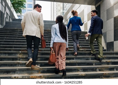 Business People Walking Up The Stairs When Going To Work In The Morning, View From The Back