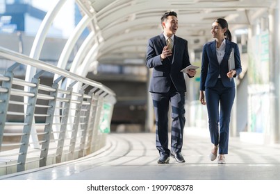 Business people walking and talk to each other in front of modern office  - Shutterstock ID 1909708378