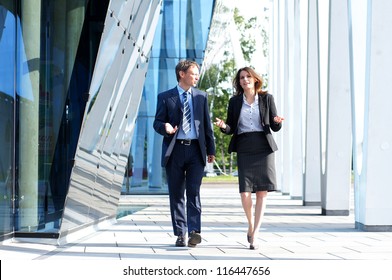 Business People Walking And Talking In The Street