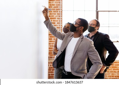 Business People Wearing Masks Brainstorming On A Whiteboard, The New Normal