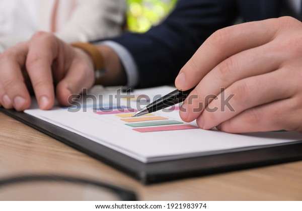 Business people working with\
documents at table in office, closeup. Investment\
analysis