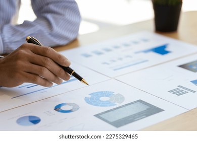 Business people working with financial documents analyzing business financial data. - Powered by Shutterstock