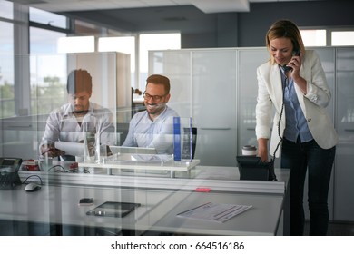 Business People Working In Office. Business Woman Talking On Landline Phone.