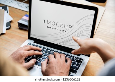 Business people working on a laptop with a screen mockup