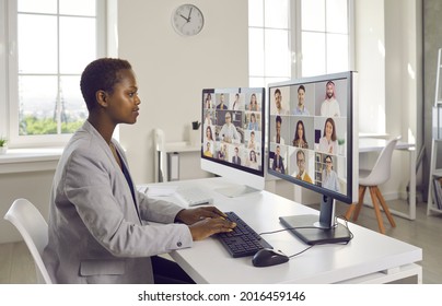 Business People Working Together In Covid Lockdown Quarantine, Talking And Discussing New Projects. Team Manager Looking At Two Desktop Computers During Virtual Staff Training Meeting With Colleagues