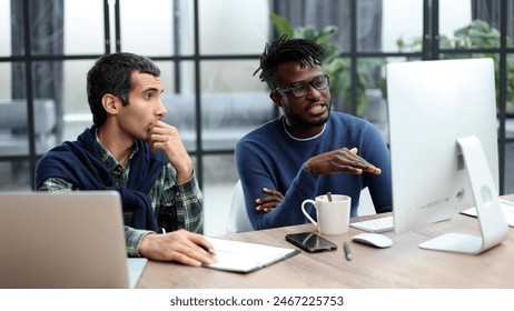 Business people working together in a modern trendy office behind a laptop - Powered by Shutterstock