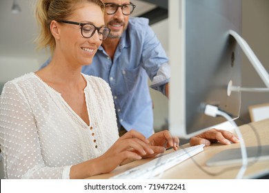 Business people working together on dektop computer