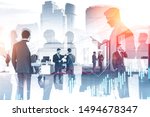 Business people working together in stylish office with double exposure of cityscape and graphs. Concept of trading and stock market. Toned image