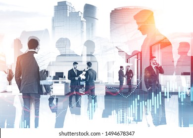 Business people working together in stylish office with double exposure of cityscape and graphs. Concept of trading and stock market. Toned image - Powered by Shutterstock