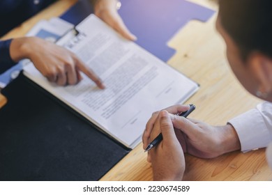 Business peoples reading documents at meeting, business partner considering contract terms before signing checking legal contract law conditions.
