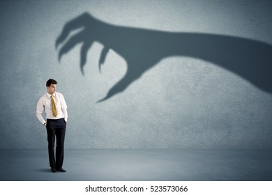 Business Person Afraid Of A Big Monster Claw Shadow Concept On Background