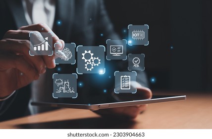 Business person dress in formal suit using digital tablet and show the component of Business that do digital transformation for industrial or manufacturing vertical