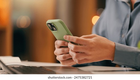 Business, person or hands with phone texting email in office for networking on app for social media. Closeup, laptop and secretary typing on mobile for research or online news on website at night