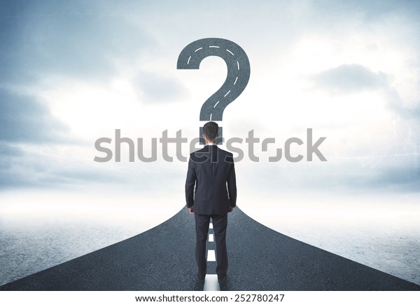 Business person lokking at road with question
mark sign concept