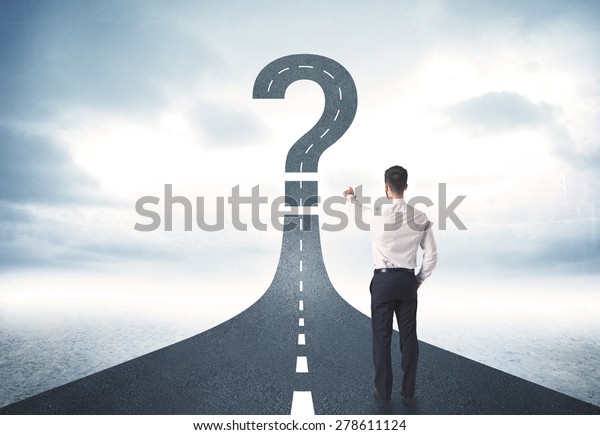 Business person lokking at road with question\
mark sign concept