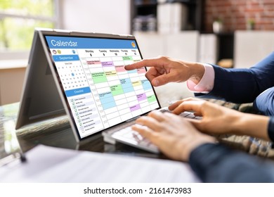 Business Person Looking At Calendar With Daily Agenda On Laptop Computer