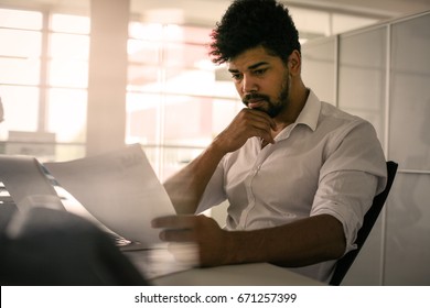 Business Person In Office. African Business Man Reading Document