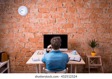 Business Person Sitting At Office Desk, Talking On Phone