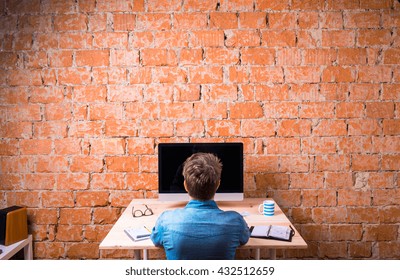 Business Person Sitting At Office Desk Working, Rear View