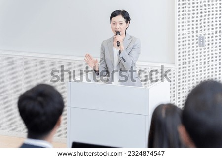 Business person speaking with microphone