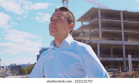 Business Person Standing In Front Of Construction Site. Office Building And Crane Background. Development, Real Estate And Investment.