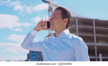 Business Person Standing In Front Of Construction Site. Office Building And Crane Background. Development, Real Estate And Investment.