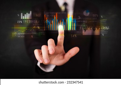 Business person touching colorful charts and diagrams