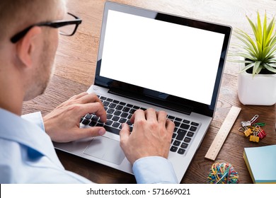 Business Person Using Laptop Computer Showing Blank Screen On Wooden Desk