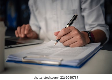 Business person Writing contract law and paper work for business and finance, write document, complete job application forms, contract real estate and insurance concept. - Powered by Shutterstock