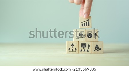 Business, personal development concept. Improving and developing  competency, performance. Hand holds wooden cubes with growth icon stading with brainstorm, training, mentor, support and improve icon