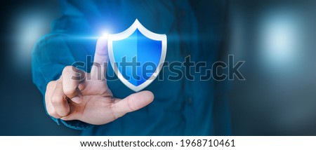 Business personnel touch the shield icon to safeguard data or networks, and virus security is ensured. Insurance and data protection Information security against viruses, business security principles