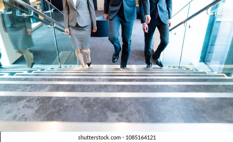 Business Persons Going Up The Stairs.