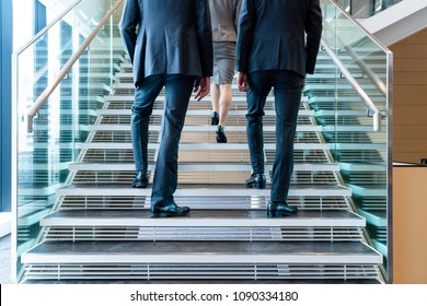 Business Persons Going Up The Stairs.