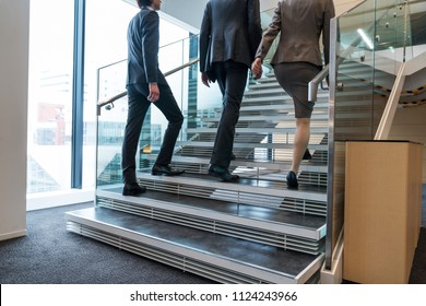 Business Persons Going Up The Stairs.