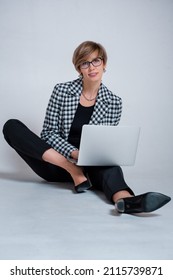 Business Photo Session Girl Sitting On The Floor Working With A Laptop