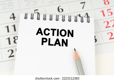 Business Planning Concept. On The Calendar Is A Notebook With The Inscription - ACTION PLAN