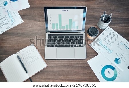 Business planning, finance and marketing with laptop on office table or desk. Social media mangement, budget graphs or ppt presentation with modern technology, notebook and paperwork above background